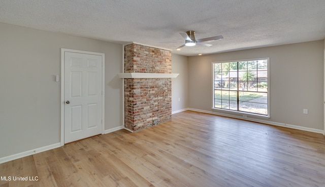 unfurnished living room featuring light hardwood / wood-style flooring, a textured ceiling, and ceiling fan