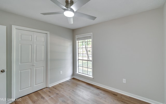 unfurnished bedroom with a closet, ceiling fan, and light wood-type flooring