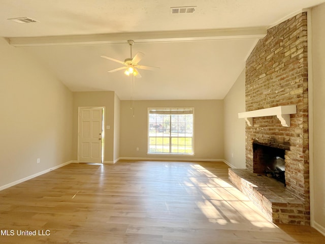 unfurnished living room with ceiling fan, lofted ceiling with beams, light hardwood / wood-style flooring, and a fireplace