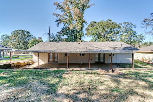 back of property featuring a yard and a patio