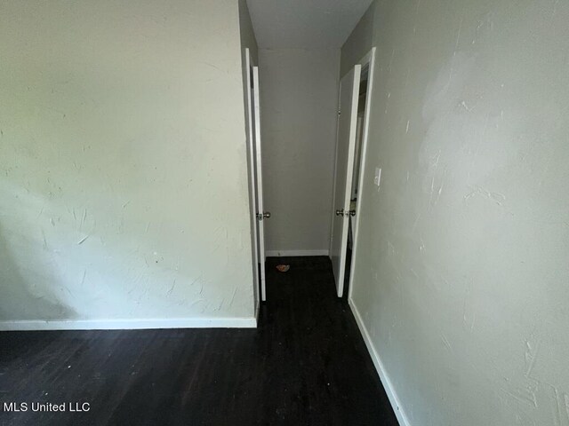 corridor with dark hardwood / wood-style floors