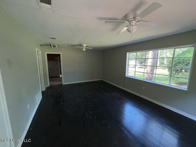 empty room with dark wood-type flooring and ceiling fan