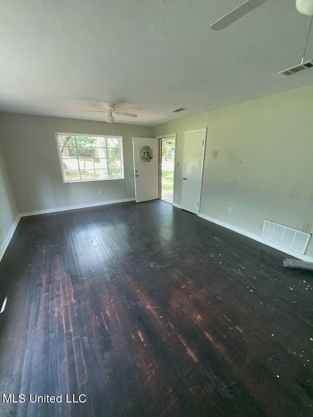 interior space featuring ceiling fan, a textured ceiling, and dark hardwood / wood-style floors