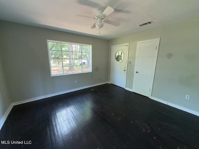 interior space featuring ceiling fan and dark hardwood / wood-style flooring