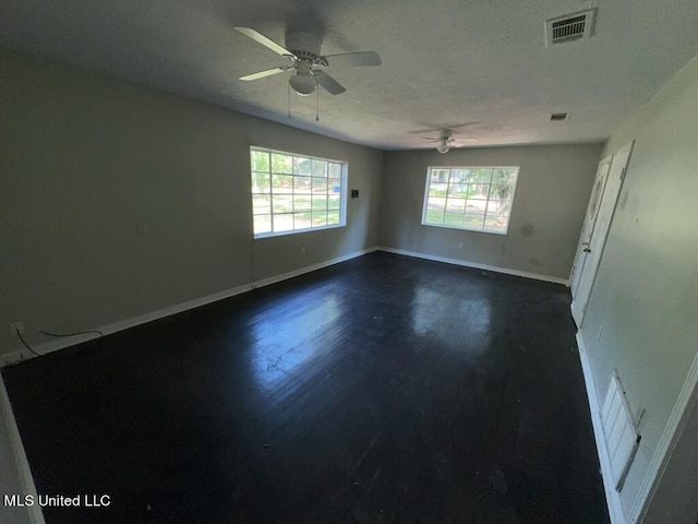 spare room featuring dark hardwood / wood-style flooring and ceiling fan