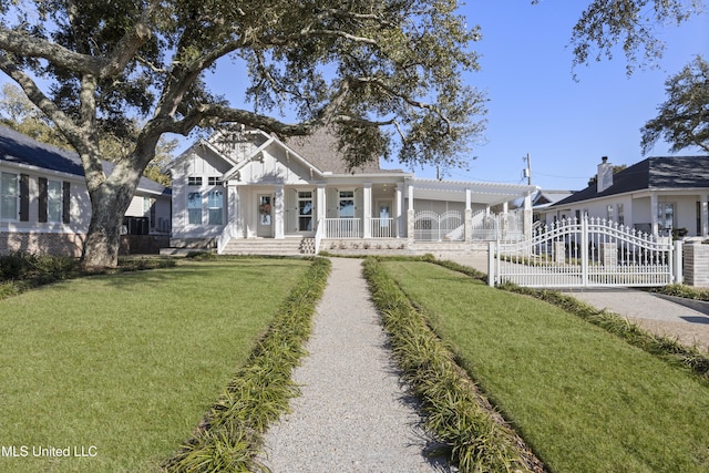 view of front of home featuring board and batten siding, a front yard, a gate, fence, and driveway