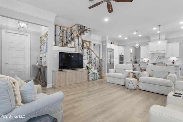 living area featuring light wood-style flooring, stairway, crown molding, and recessed lighting