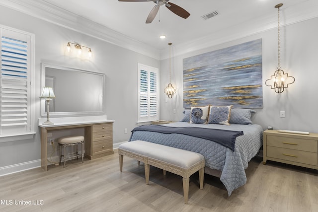 bedroom featuring ornamental molding, baseboards, visible vents, and light wood finished floors