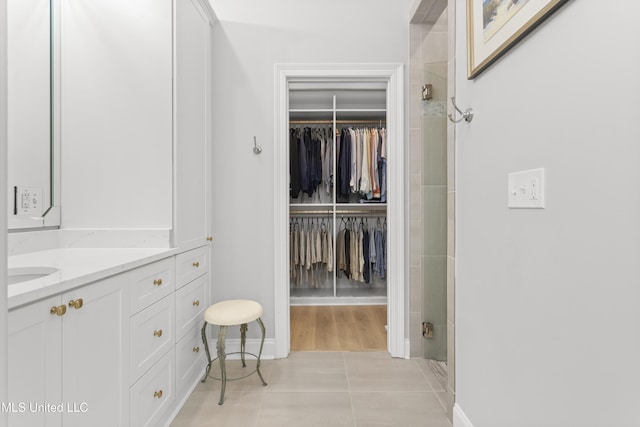 walk in closet with light tile patterned flooring