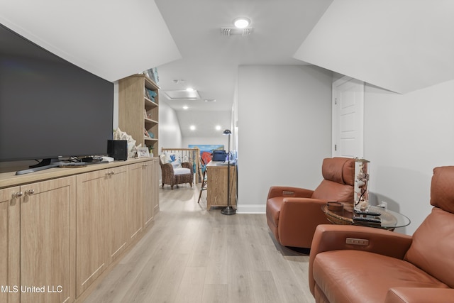 sitting room with light wood-type flooring, baseboards, visible vents, and attic access