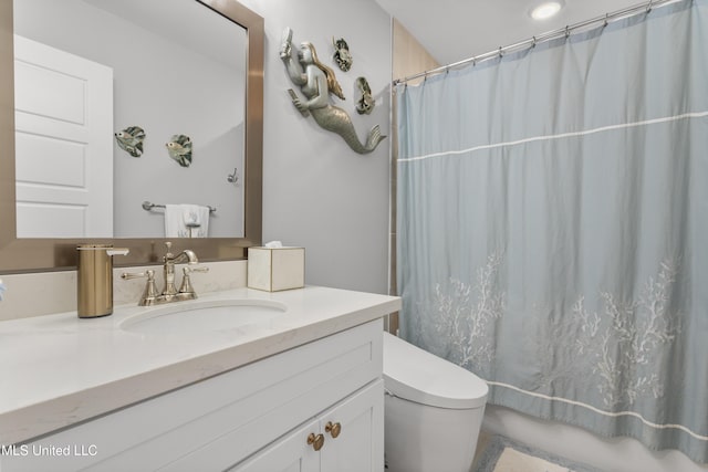 bathroom featuring toilet, shower / tub combo, and vanity