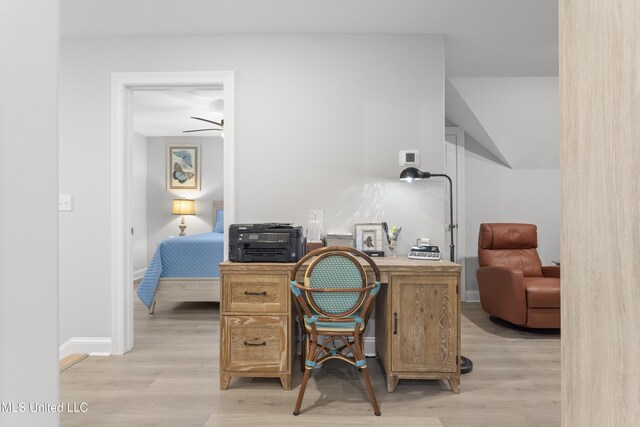 office space with light wood-style flooring and baseboards