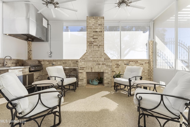 sunroom / solarium featuring a sink and a ceiling fan