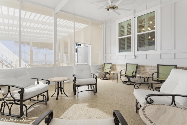 sunroom / solarium featuring ceiling fan