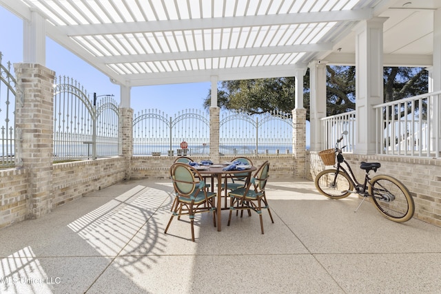 view of patio featuring fence, a pergola, and outdoor dining space