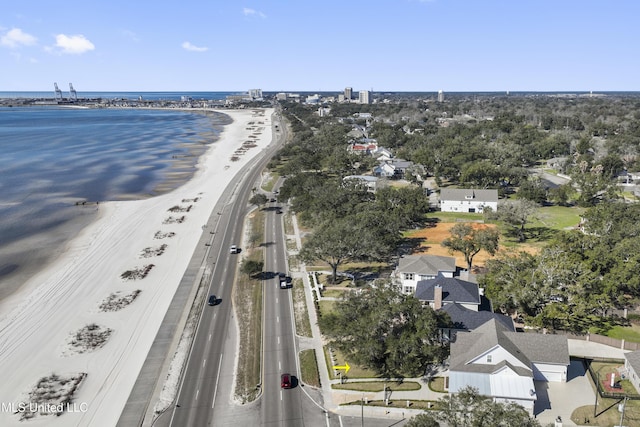 drone / aerial view featuring a water view and a view of the beach