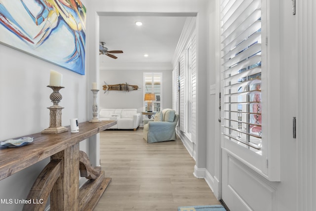 living area featuring recessed lighting, a ceiling fan, baseboards, light wood-style floors, and crown molding