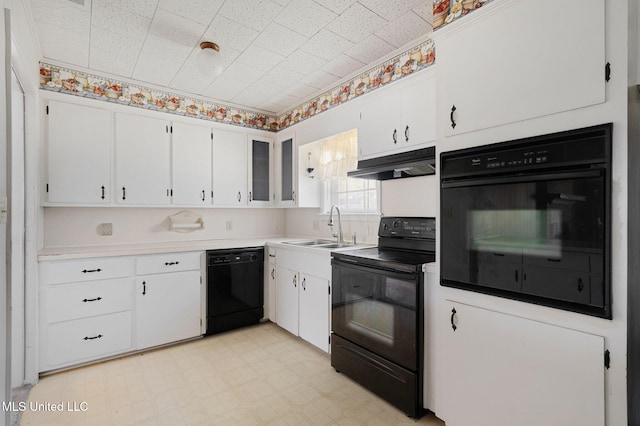 kitchen with white cabinetry, sink, and black appliances