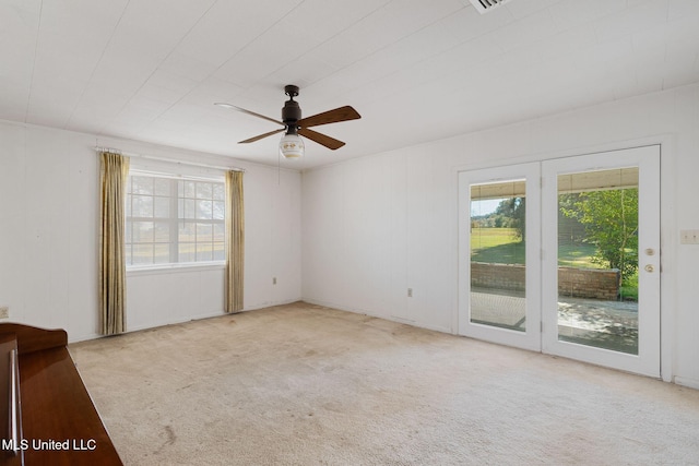 carpeted empty room with ceiling fan