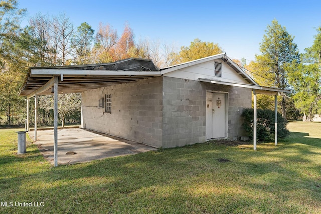 exterior space with a front lawn and a carport