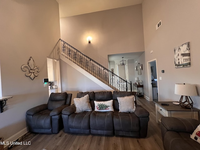 living room with high vaulted ceiling and hardwood / wood-style flooring