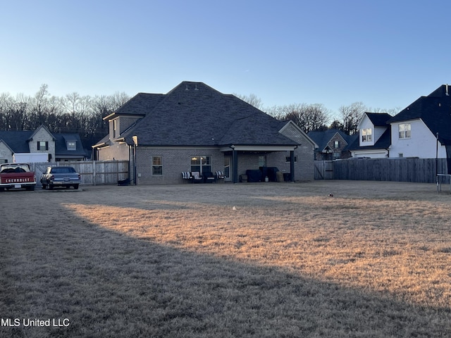 back of property featuring a lawn