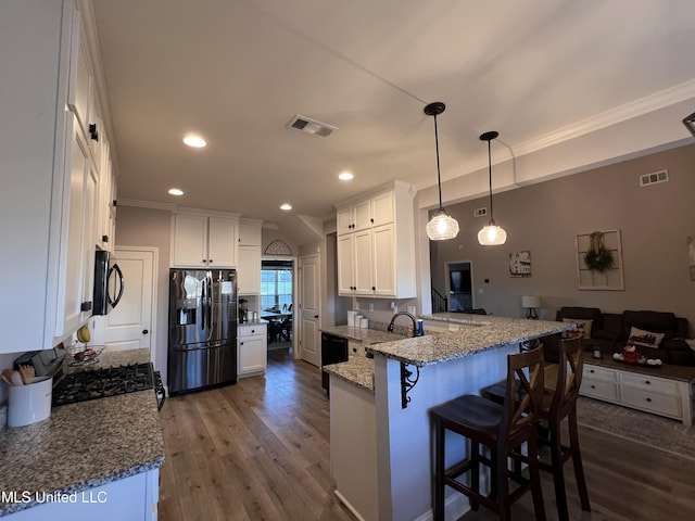 kitchen featuring pendant lighting, dark wood-type flooring, stainless steel fridge, white cabinetry, and kitchen peninsula