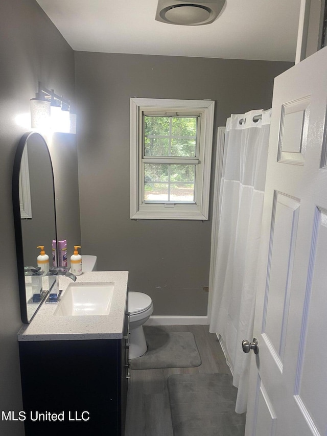 bathroom with vanity, hardwood / wood-style flooring, toilet, and a shower with shower curtain