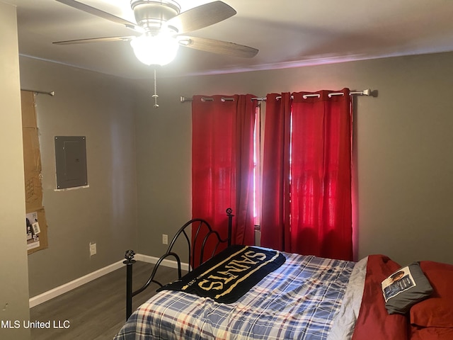 bedroom featuring electric panel, hardwood / wood-style flooring, and ceiling fan