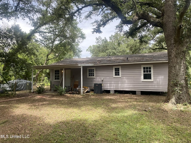 rear view of house with a yard and central AC unit