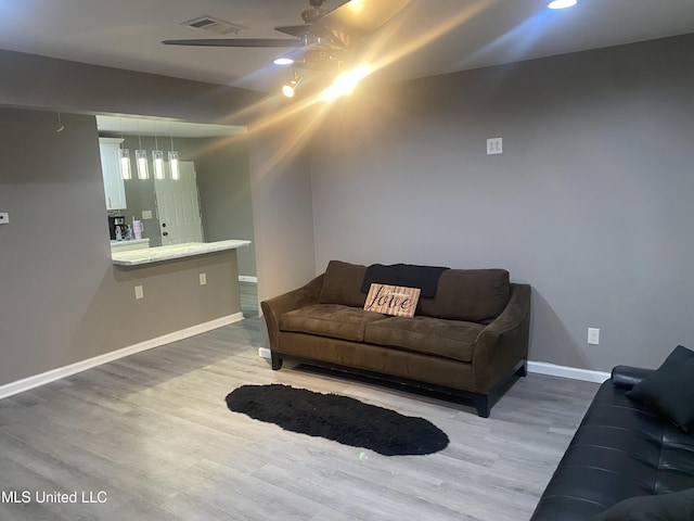 living room with hardwood / wood-style floors and ceiling fan