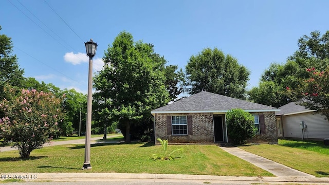 2290 Monica Dr, Gulfport, MS 39507 - view of front of home featuring brick siding, a front yard, and roof with shingles