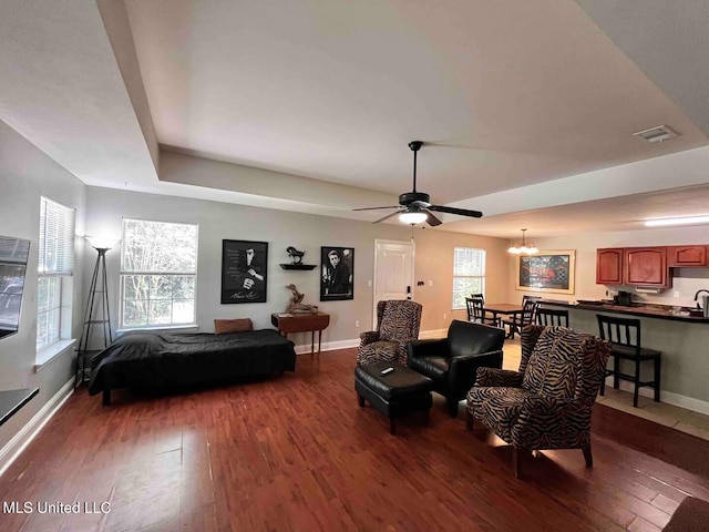 2290 Monica Dr, Gulfport, MS 39507 - living room featuring wood finished floors, baseboards, ceiling fan, a chandelier, and a raised ceiling