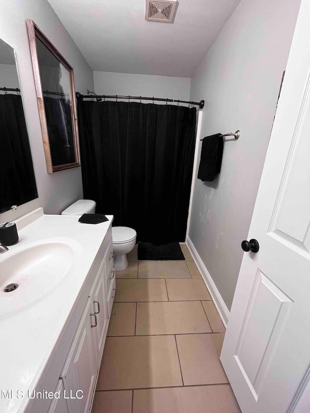 2290 Monica Dr, Gulfport, MS 39507 - full bathroom featuring vanity, toilet, tile patterned floors, and a shower with shower curtain