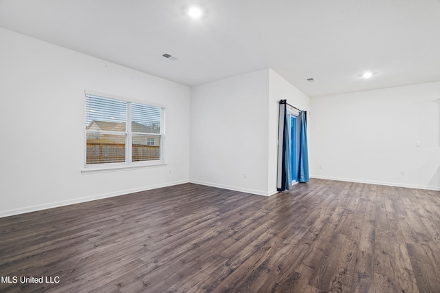 empty room with dark hardwood / wood-style floors