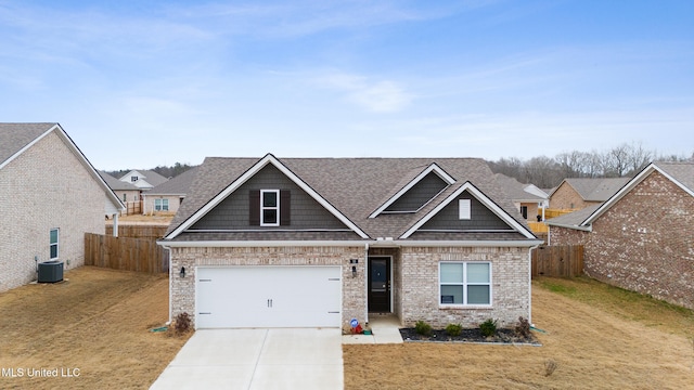 craftsman inspired home with cooling unit, a garage, and a front yard