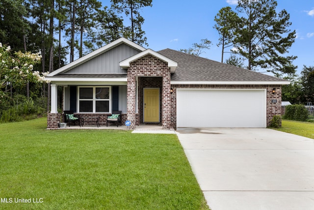 craftsman inspired home with a front yard, a garage, and covered porch