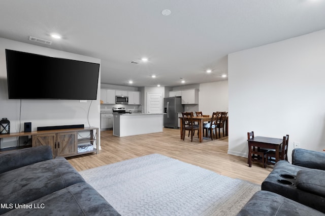 living room with light hardwood / wood-style flooring