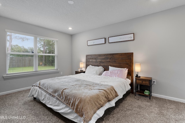 bedroom featuring carpet flooring and a textured ceiling