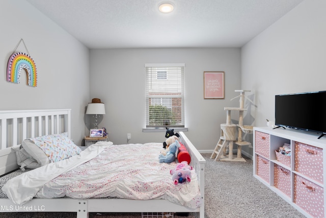 bedroom with a textured ceiling and carpet floors