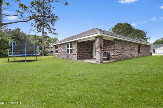 view of home's exterior featuring a yard, a patio, and a trampoline