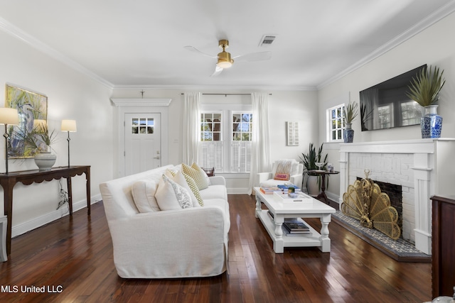 living room with visible vents, crown molding, wood finished floors, a fireplace, and ceiling fan