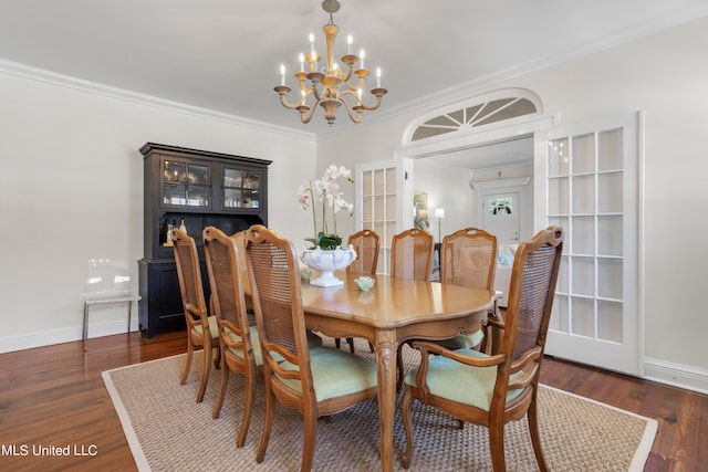 dining space featuring ornamental molding, dark hardwood / wood-style flooring, and a chandelier