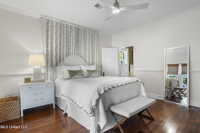 bedroom with crown molding, ensuite bathroom, dark wood-style flooring, and visible vents