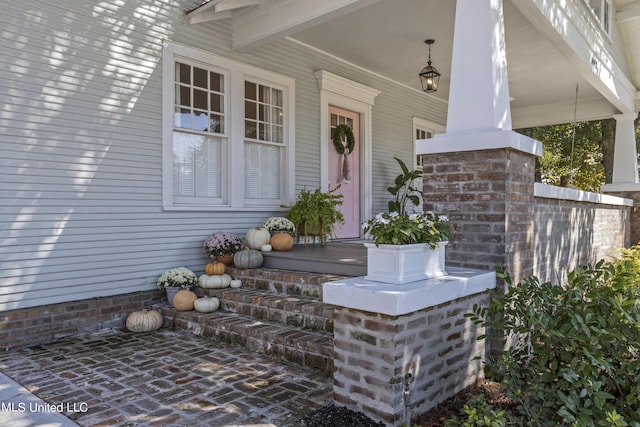 view of exterior entry with a porch