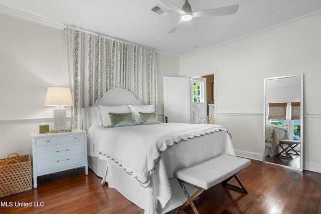 bedroom with dark wood-type flooring, crown molding, and ceiling fan