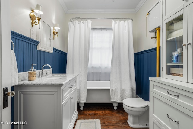 full bathroom featuring hardwood / wood-style floors, shower / bath combination with curtain, toilet, vanity, and crown molding