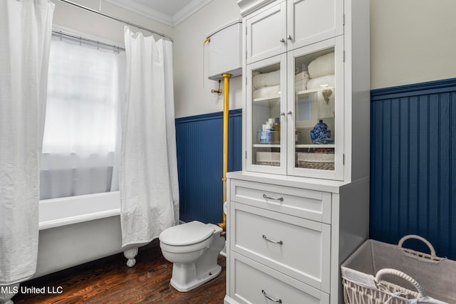 bathroom featuring ornamental molding, hardwood / wood-style floors, shower / bath combination with curtain, and toilet