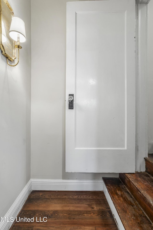interior space featuring baseboards and wood finished floors