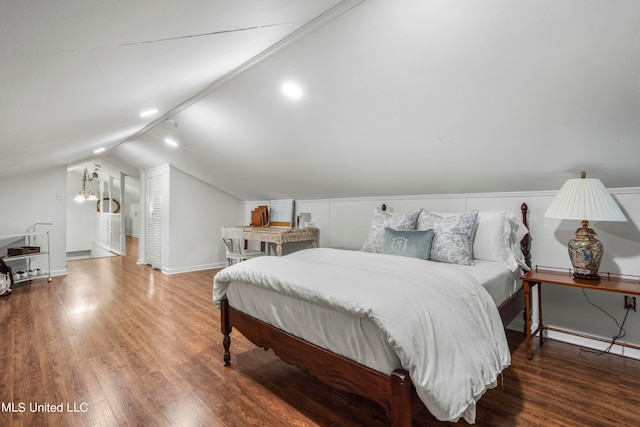 bedroom with lofted ceiling and dark hardwood / wood-style floors